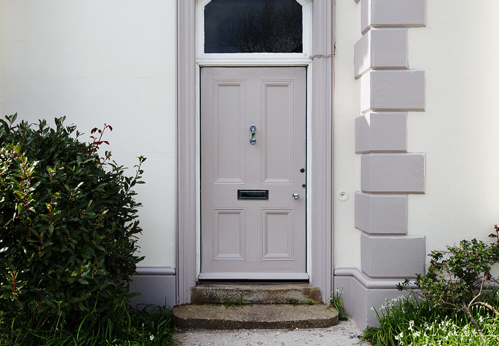 A grey composite entrance door with knocker and letterbox