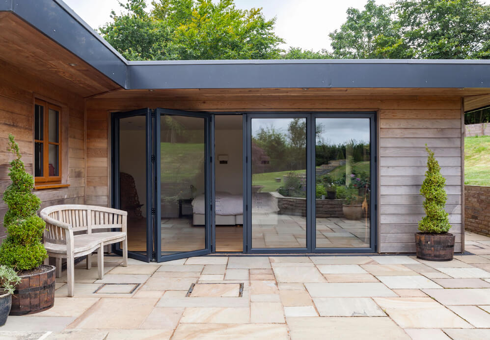 External view of grey aluminium bi folding door with large glass area