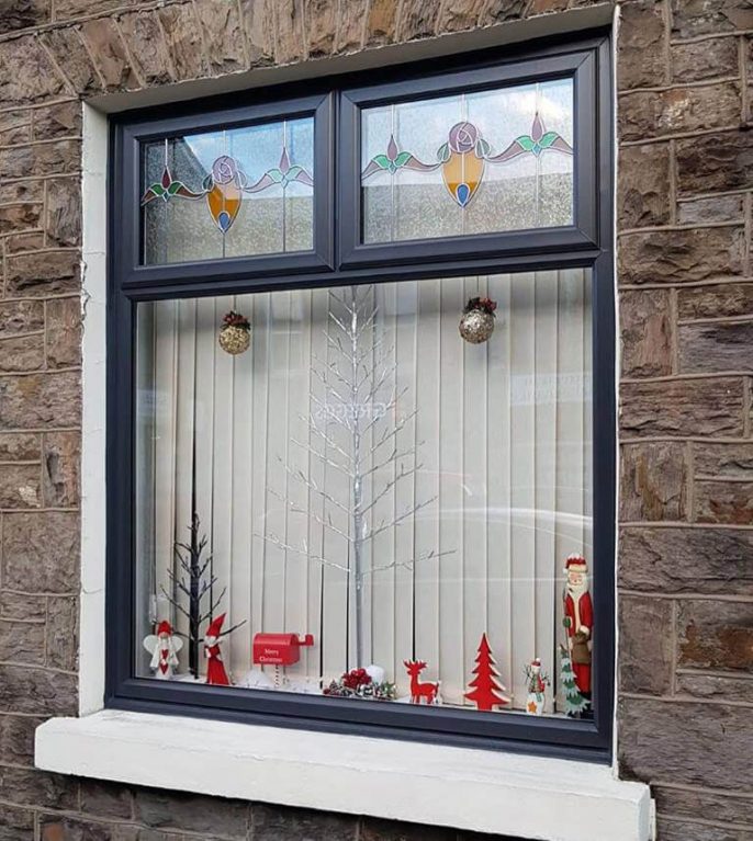 Casement windows with custom stained glass decorative detail