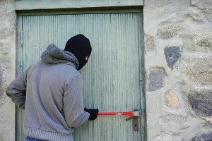 A burglar trying to break into a door