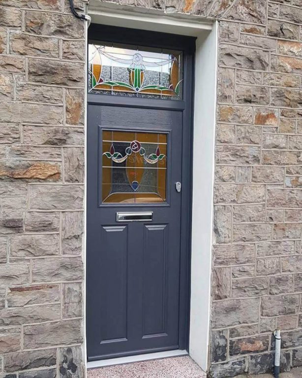 Composite entrance door with custom decorative glass