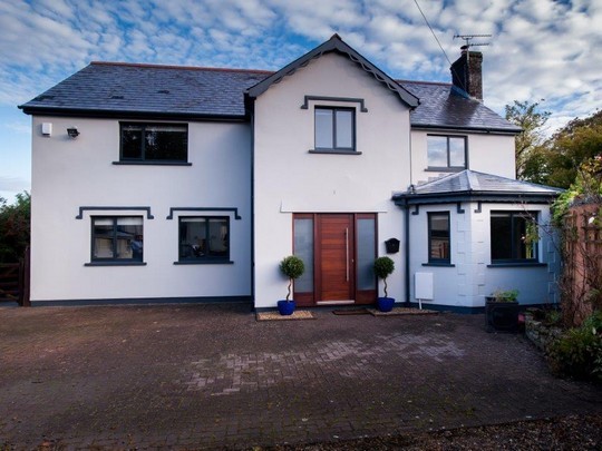 grey aluminium windows with wood effect front door