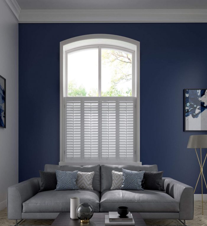 White privacy shutters fitted over a tall window