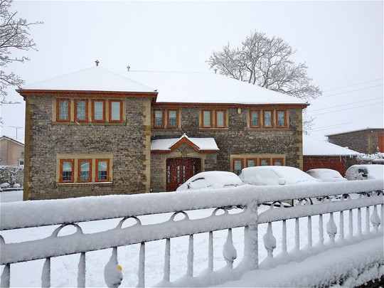 snow covered house with oak effect upvc windows