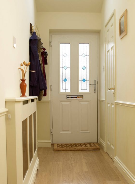 Internal view of white composite front door with decorative glass