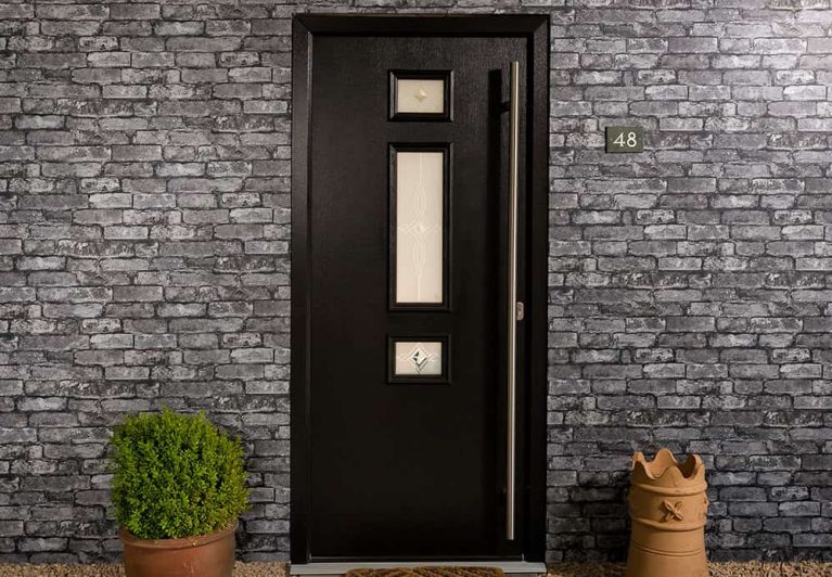 A modern composite front door with glazed panels