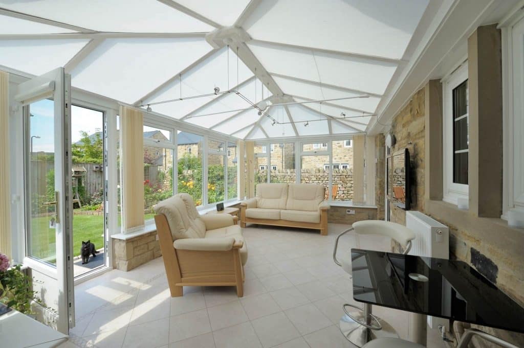 Large conservatory with glazed roofs and blinds installed