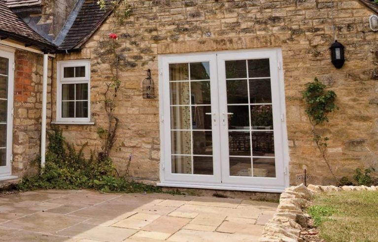 Old brick home with traditional style french doors and windows
