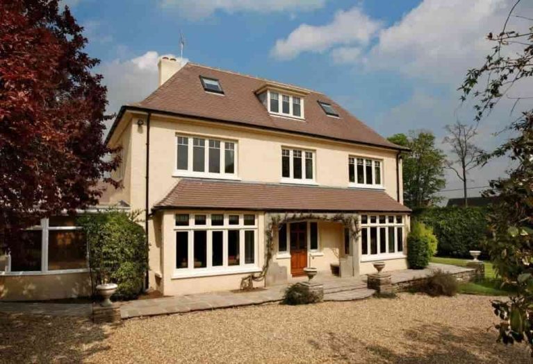 Cream aluminium windows external view of entire property and drive