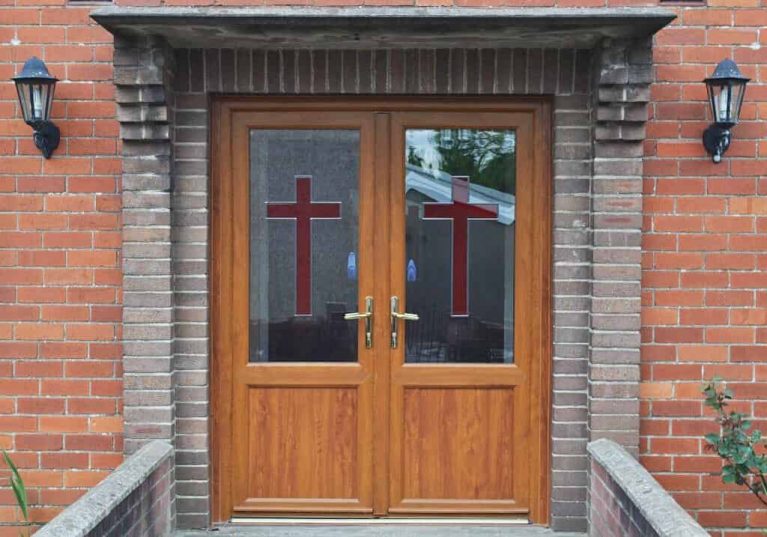 Double front doors with decorative glass for church