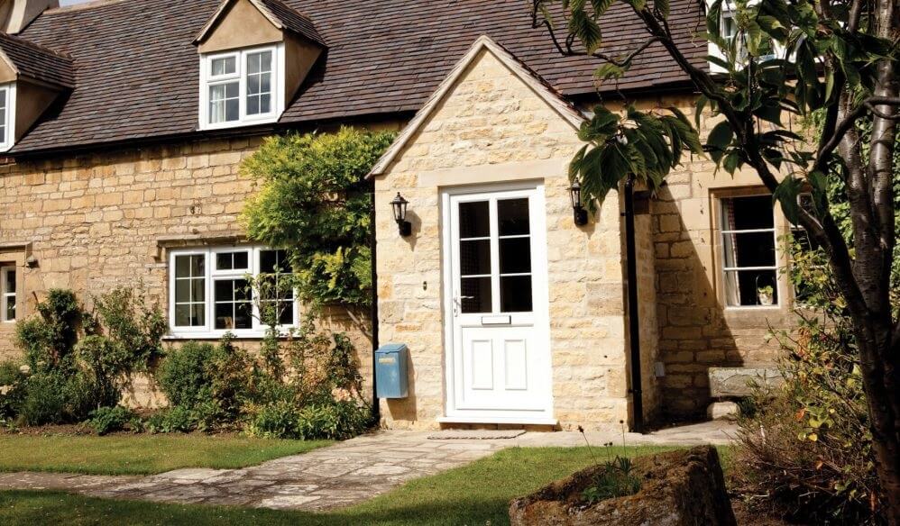 Traditional style home with a white uPVC door with a large glazed pane and astragal bar detail