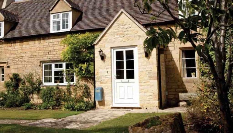 Traditional style home with a white uPVC door with a large glazed pane and astragal bar detail