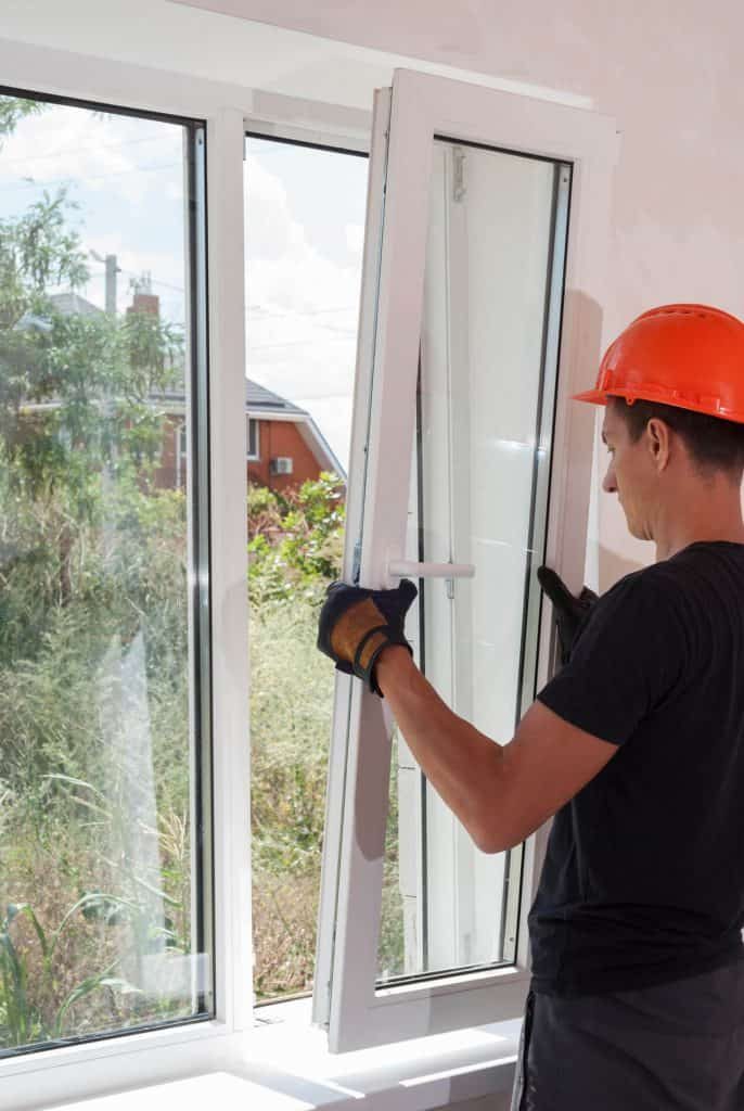 Repair men carrying out repairs on a window