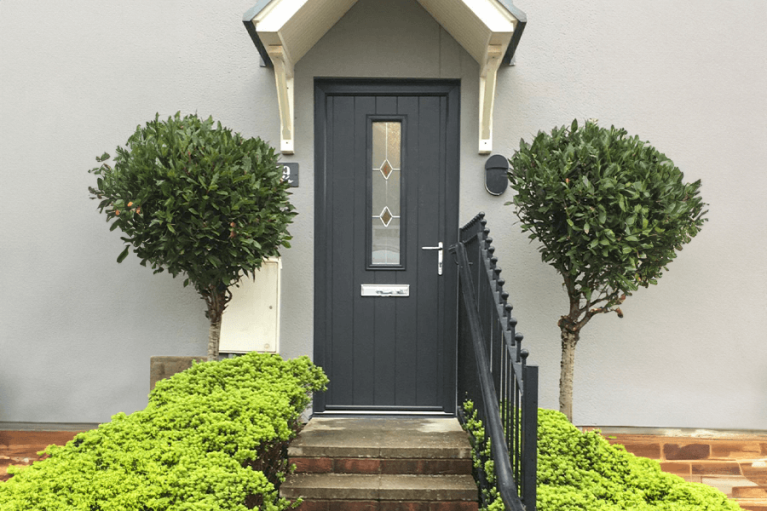 Anthracite grey Endurance composite front door with glazed panel and chrome handle.